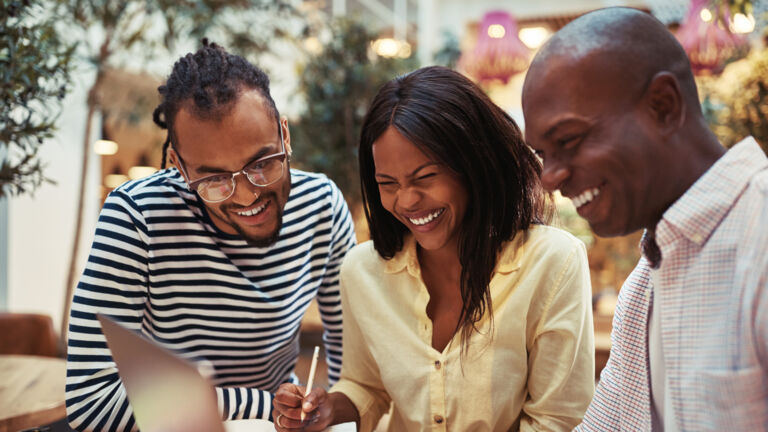 Three African American people going over business ideas